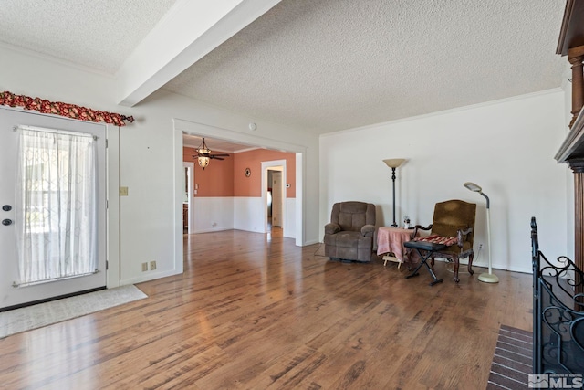 entryway with beamed ceiling, ceiling fan, hardwood / wood-style floors, and a textured ceiling