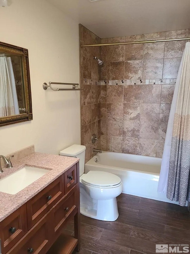 full bathroom featuring wood-type flooring, vanity, toilet, and shower / bathtub combination with curtain