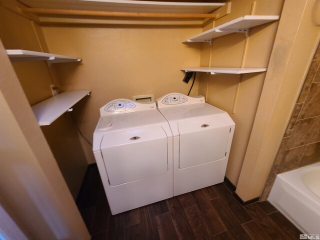 laundry area featuring dark wood-type flooring and washing machine and clothes dryer