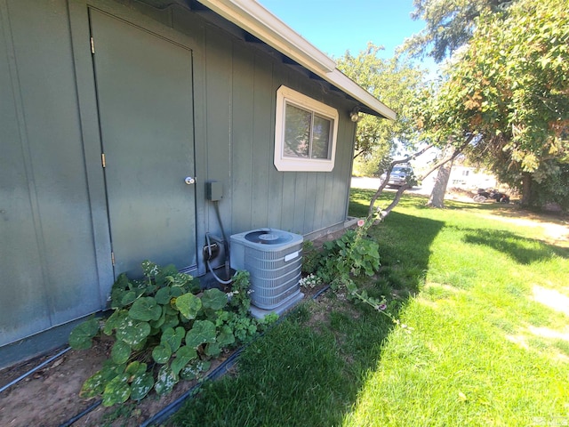 exterior space featuring a yard and central AC