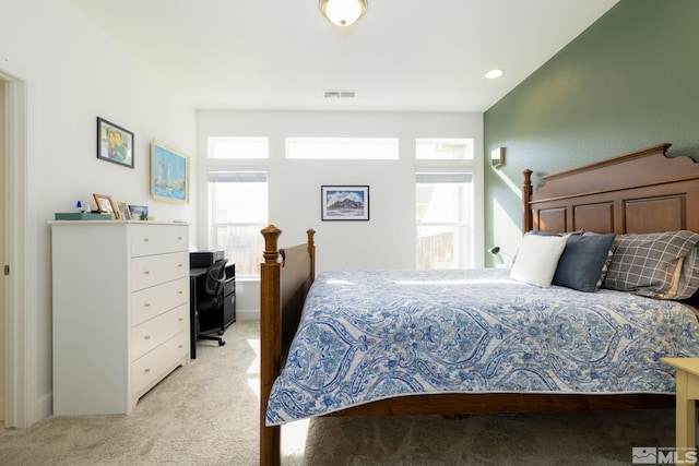 carpeted bedroom with multiple windows