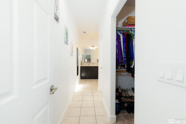 corridor featuring light tile patterned floors