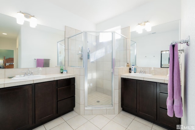 bathroom with tile patterned flooring, vanity, and a shower with shower door