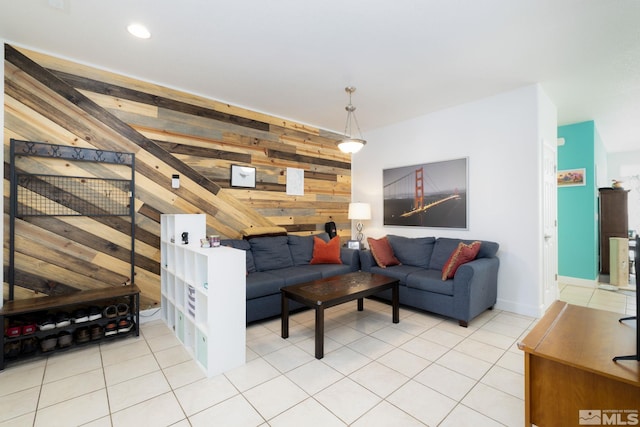 living room featuring light tile patterned floors and wooden walls