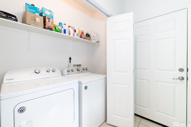 washroom with separate washer and dryer and light tile patterned floors