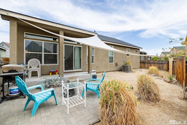 rear view of property featuring a patio and central air condition unit