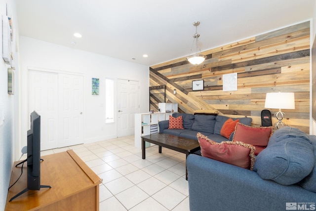 living room with light tile patterned flooring and wood walls