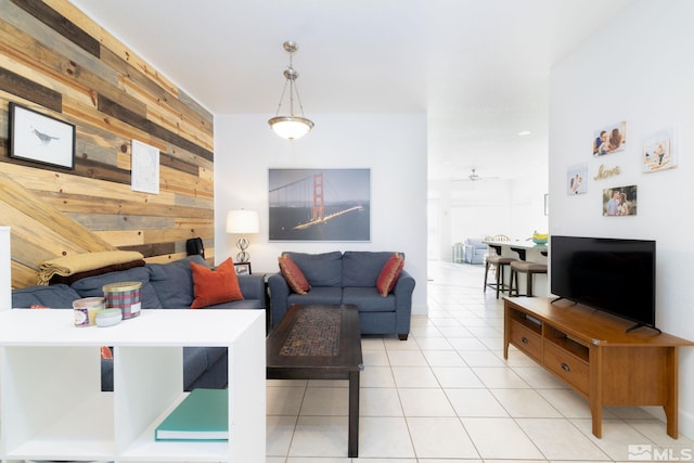 tiled living room featuring wood walls and ceiling fan