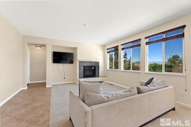 living room featuring a tiled fireplace