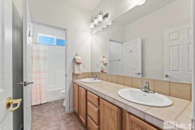 full bathroom featuring shower / bath combo, vanity, and toilet