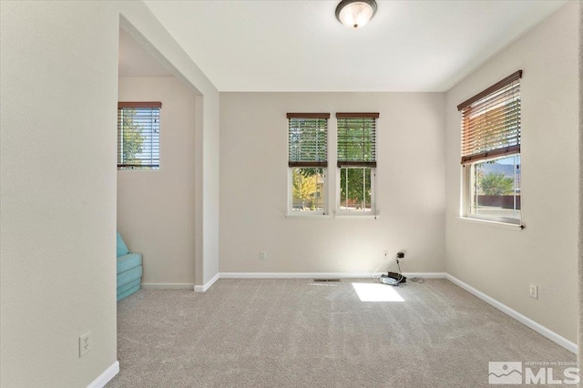 spare room with light carpet and a healthy amount of sunlight