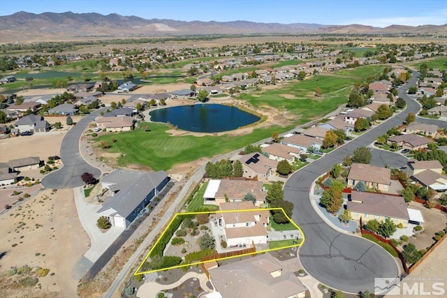 birds eye view of property with a water and mountain view