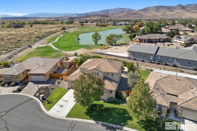 birds eye view of property with a water and mountain view