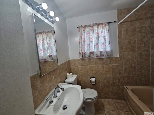 full bathroom featuring tile patterned flooring, tile walls, sink, and toilet