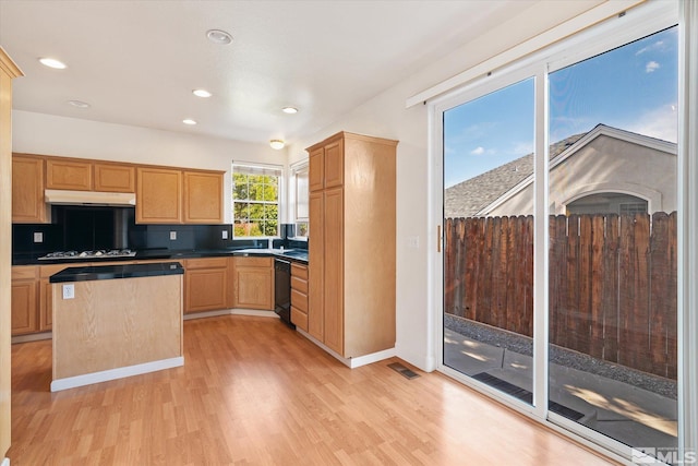 kitchen featuring sink, light hardwood / wood-style flooring, backsplash, gas cooktop, and black dishwasher