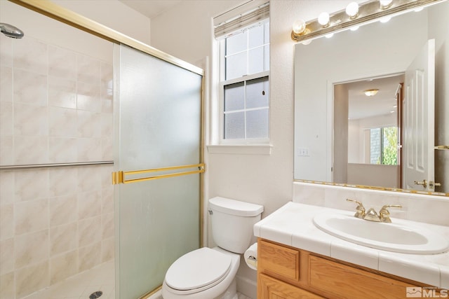 bathroom featuring walk in shower, vanity, and toilet