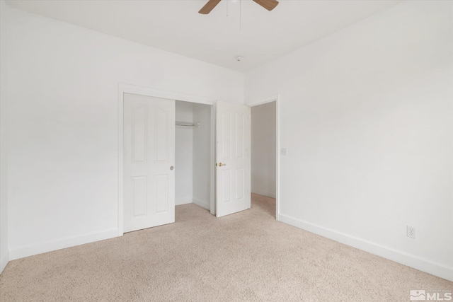 unfurnished bedroom featuring a closet, light colored carpet, and ceiling fan