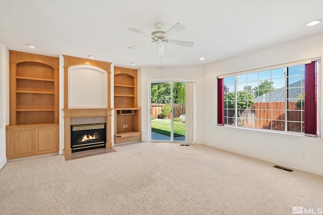 unfurnished living room with ceiling fan and light colored carpet