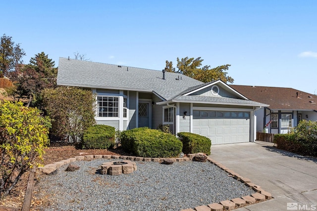 single story home featuring a garage and an outdoor fire pit