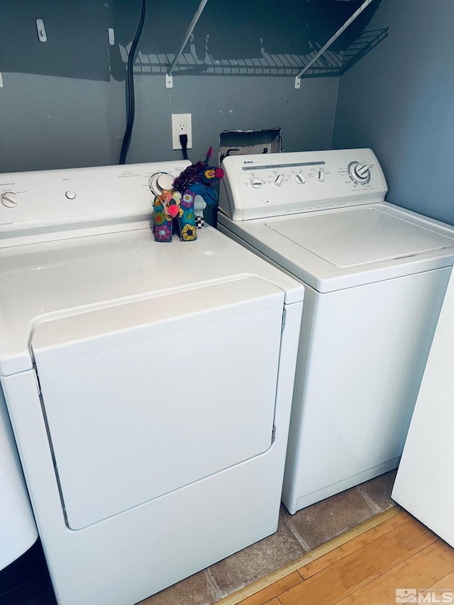 washroom featuring light wood-style flooring, independent washer and dryer, and laundry area