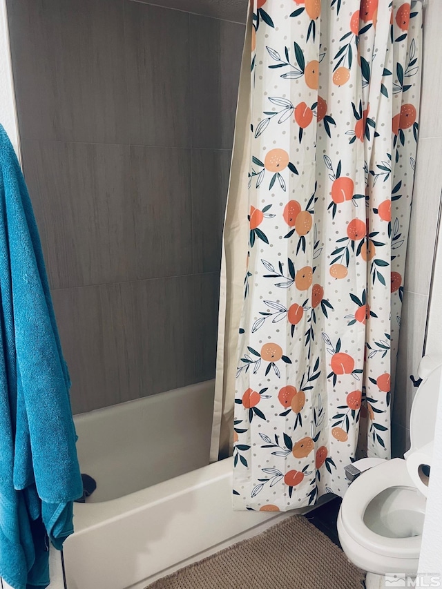 bathroom with shower / bathtub combination with curtain and toilet