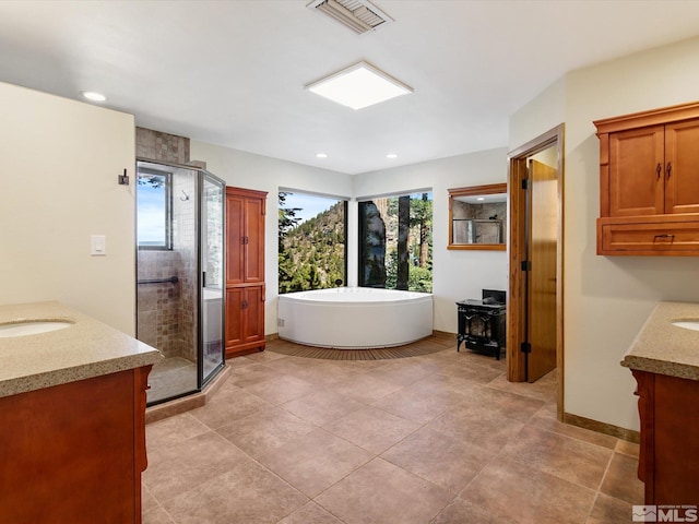 bathroom with shower with separate bathtub, tile patterned floors, and vanity