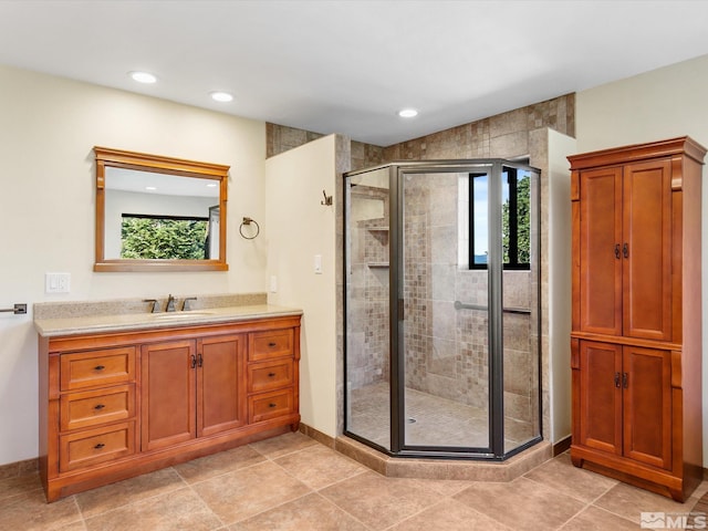 bathroom with vanity, tile patterned flooring, and an enclosed shower