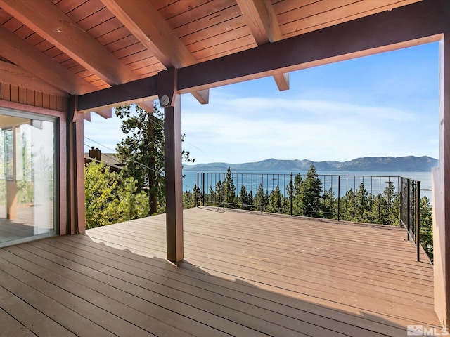 wooden deck featuring a water and mountain view