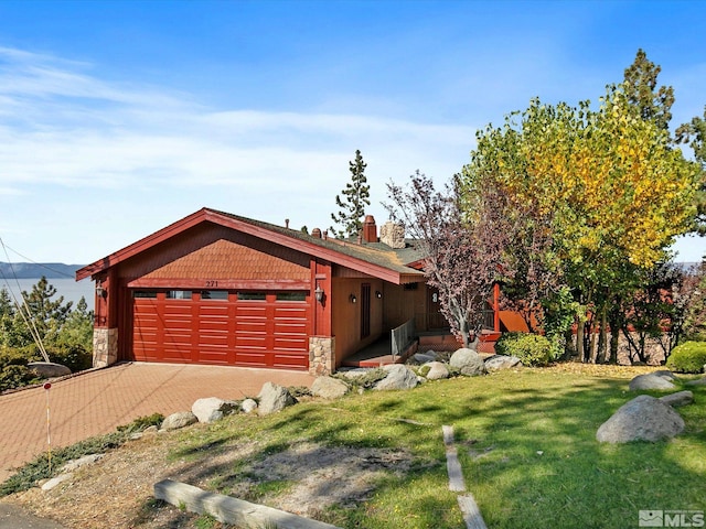 view of front facade with a front yard and a garage