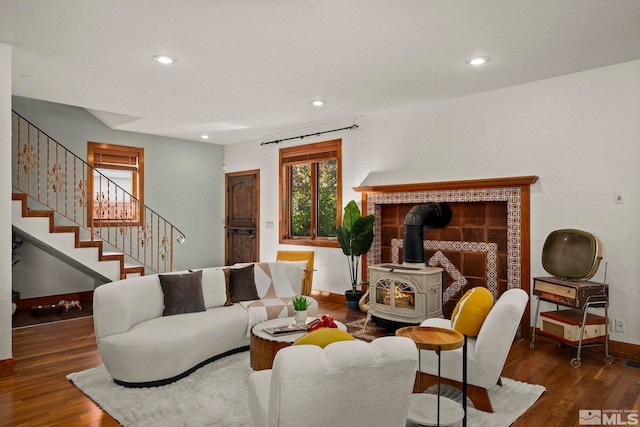 living room with dark hardwood / wood-style floors and a wood stove