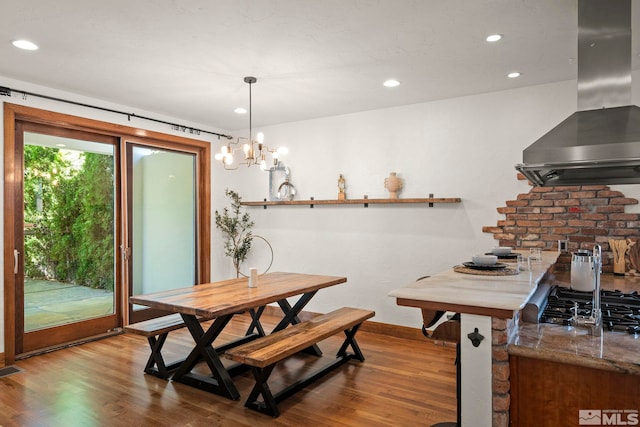 dining space with an inviting chandelier and light wood-type flooring