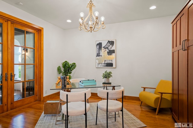 home office featuring french doors, an inviting chandelier, and light wood-type flooring