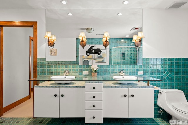 bathroom featuring tile walls, vanity, and toilet