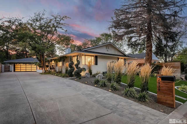 view of front facade with a garage and a lawn