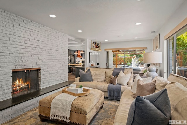 living room with a large fireplace and plenty of natural light