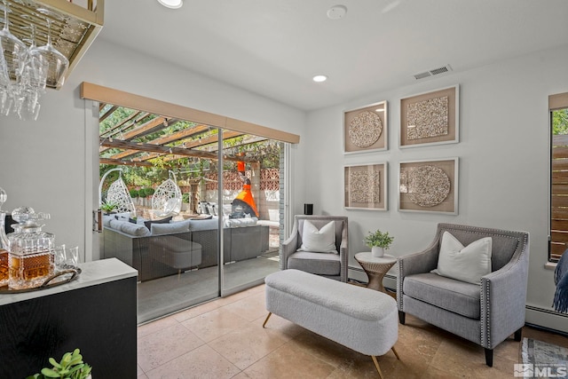 sitting room with light tile patterned flooring and a baseboard radiator