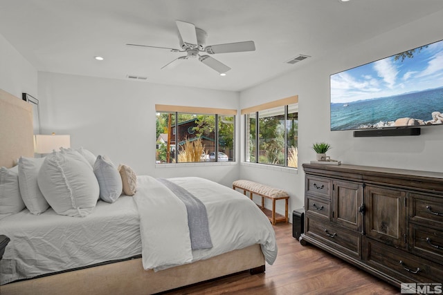 bedroom with dark hardwood / wood-style flooring and ceiling fan