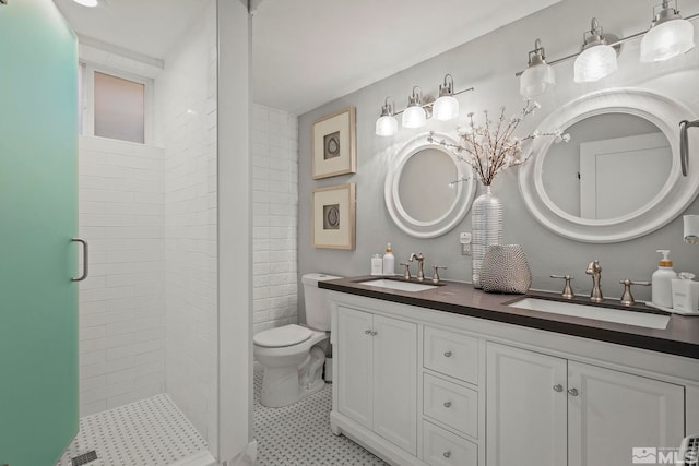 bathroom with tile patterned flooring, walk in shower, vanity, and toilet