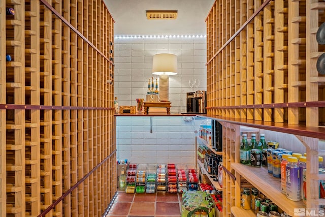 wine cellar with tile patterned floors and tile walls