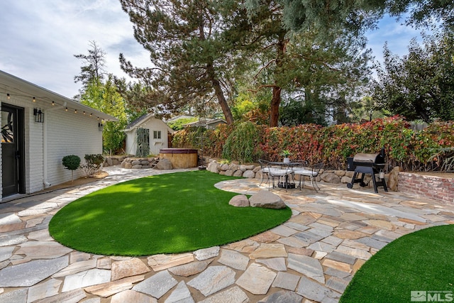 view of yard with a hot tub and a patio area