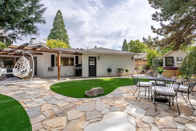 rear view of property featuring a lawn, a patio area, and a pergola