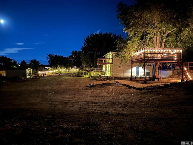 yard at twilight featuring a wooden deck