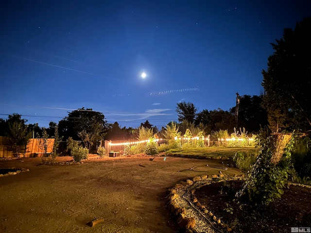 view of yard at twilight