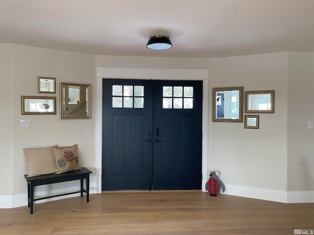 foyer entrance with light hardwood / wood-style floors