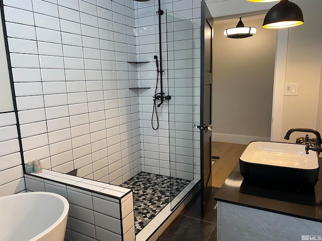 bathroom with vanity, separate shower and tub, and hardwood / wood-style flooring