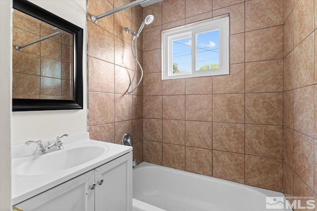 bathroom with vanity and tiled shower / bath combo