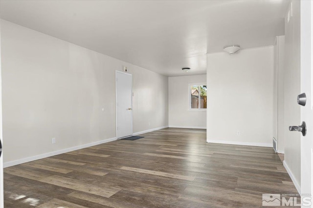 spare room featuring dark wood-type flooring