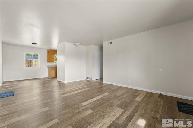 unfurnished living room featuring wood-type flooring