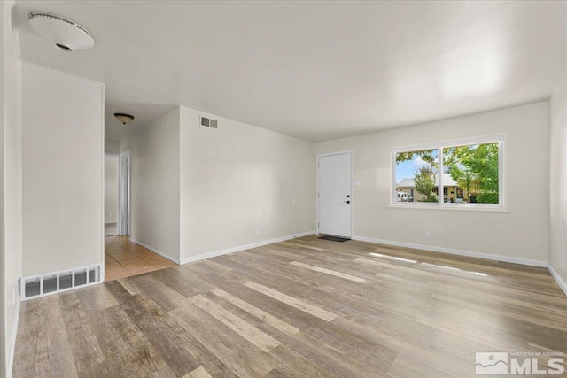 spare room featuring light hardwood / wood-style flooring