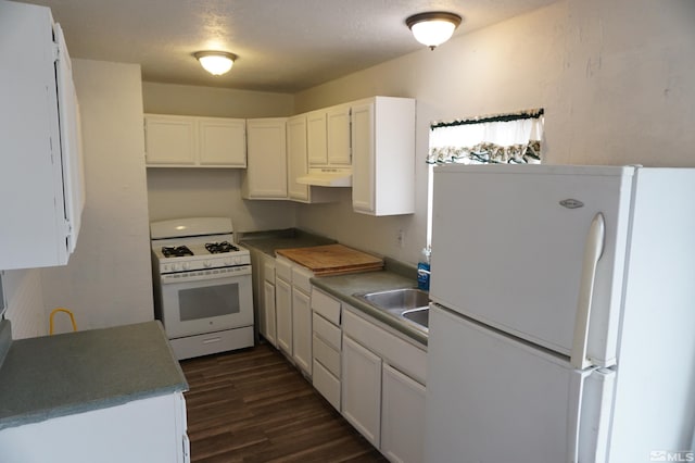 kitchen with white appliances, sink, dark hardwood / wood-style flooring, and white cabinetry